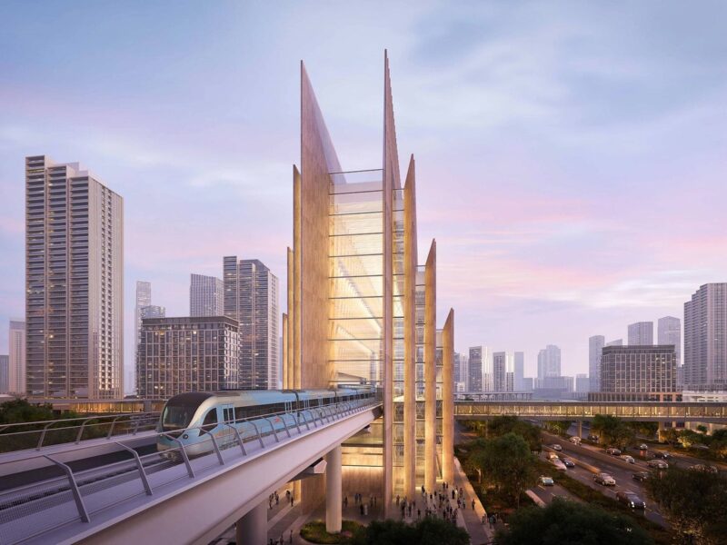 Render of a Blue Line train on an elevated viaduct beside Emaar Properties Station at Dubai Creek Harbour