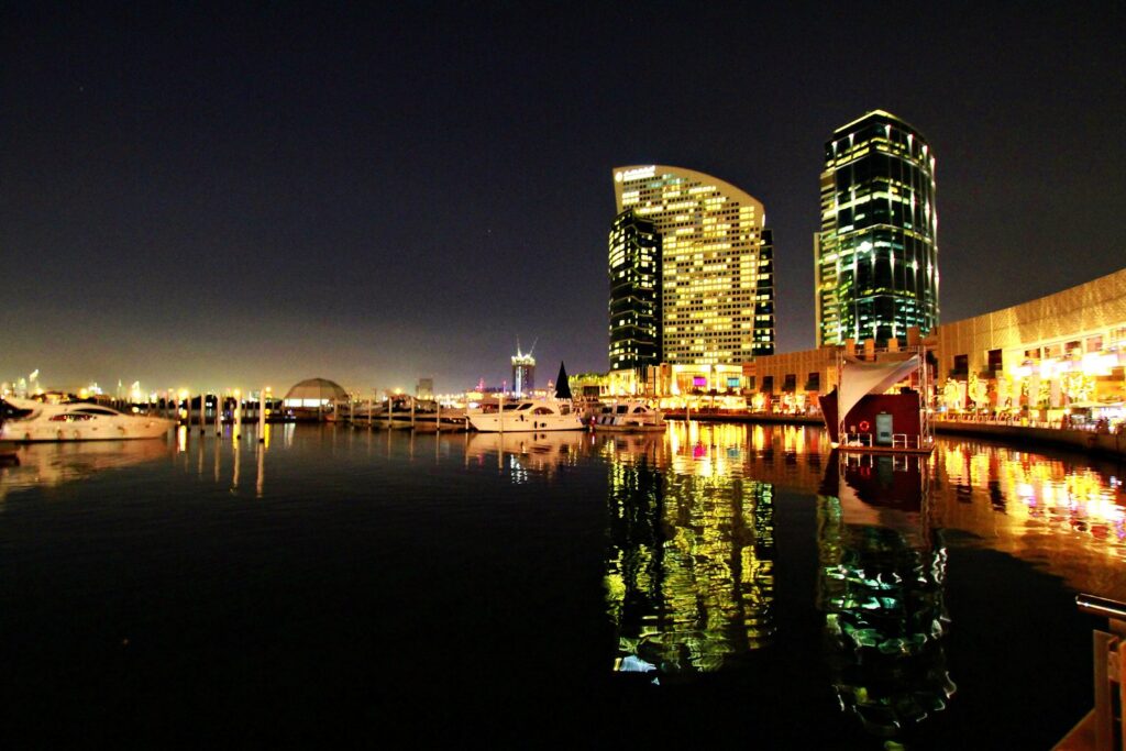 Dubai Festival City marina at night with hotel towers