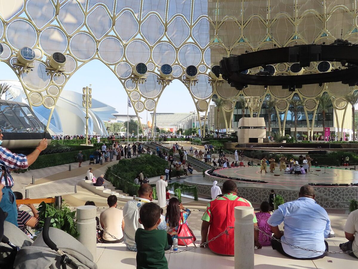 Al Wasl Plaza at Expo City Dubai, with its lattice dome and visitors watching a stage