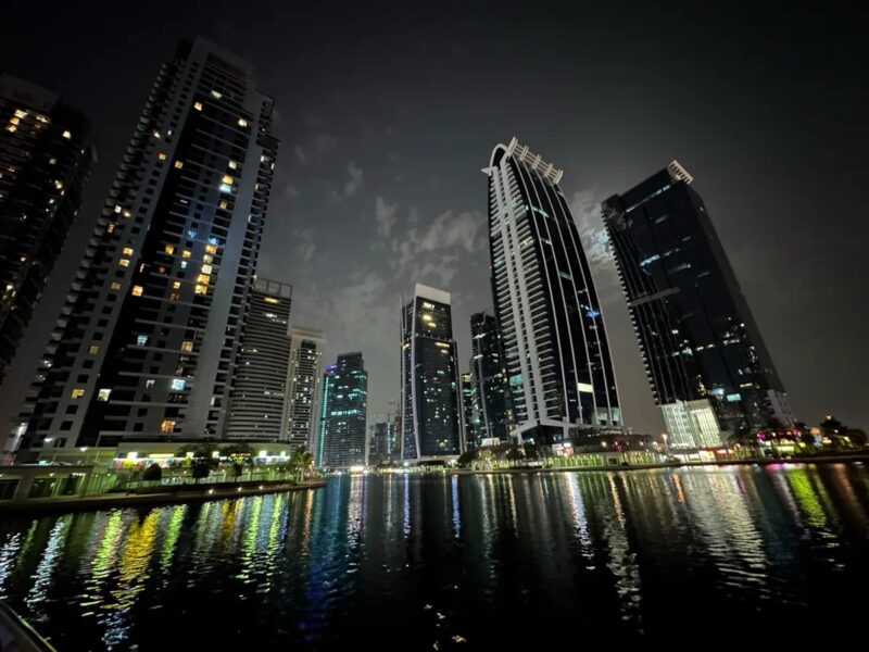 Residential towers by the water at Jumeirah Lakes Towers in Dubai at night